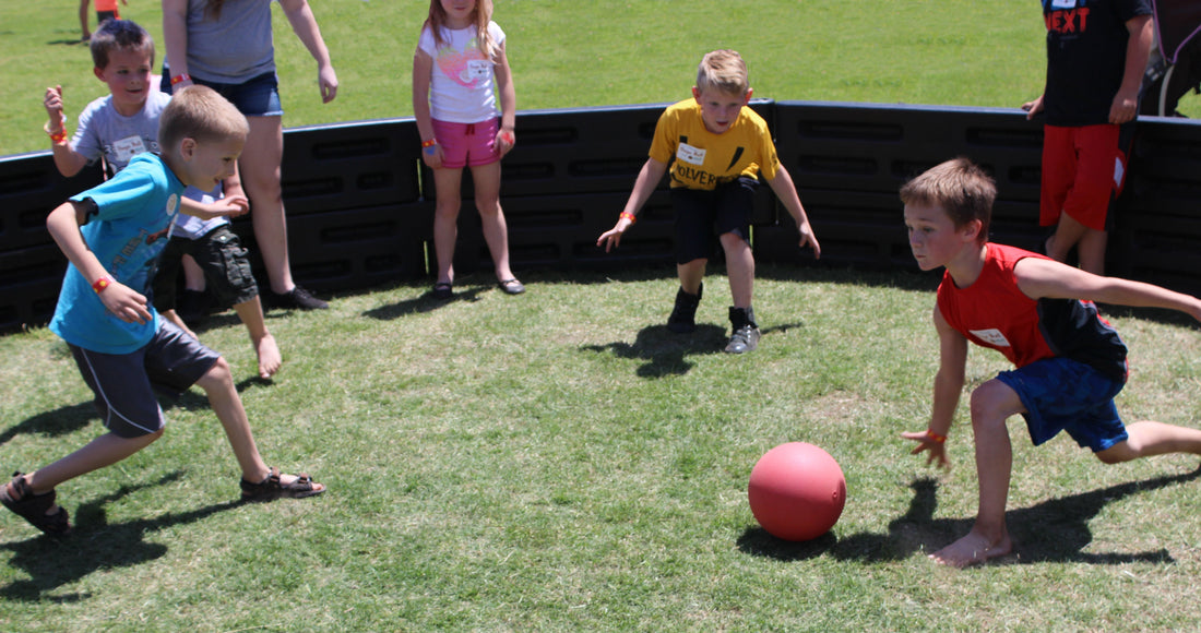 Kids playing Gaga Ball on grass